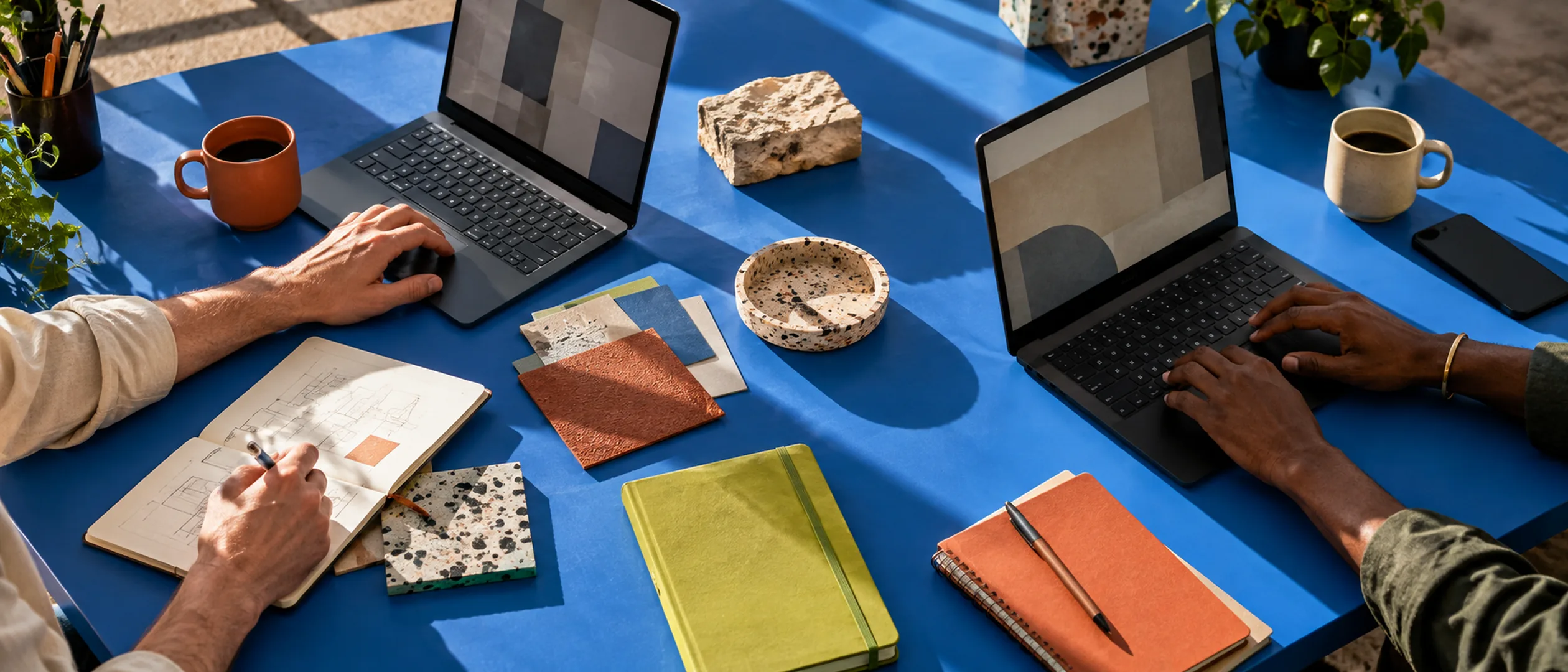 A team working together around a table with laptops and notebooks
